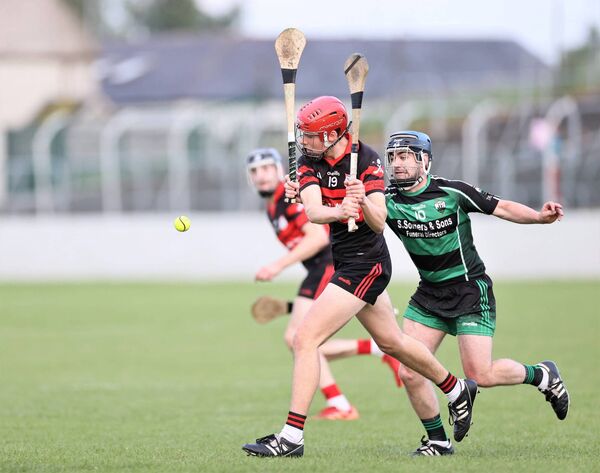 Mark Dundon from MLR gets in his clearance with Richie Whelan from Bagenalstown Gaels trying to block Photo: Pat Ahern
