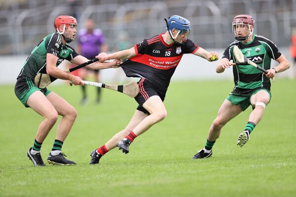 Jamie Nolan from MLR has his jersey tested by Niall Bolger from Bagenalstown Gaels.