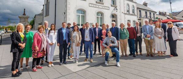 The Entente Floral judges pictured with local political representatives, members of Carlow Tidy Towns and Carlow County Council, along with uilleann piper Killian Townsend, outside Carlow Town Hall last Friday