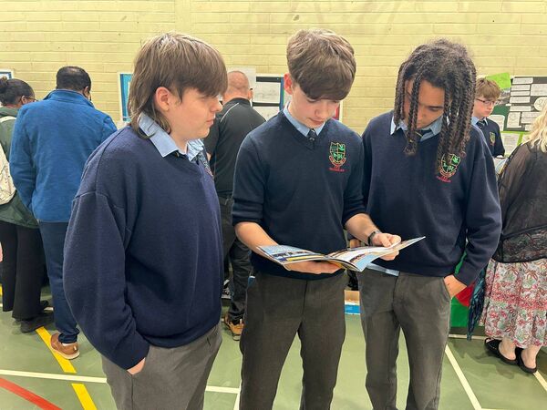 Brian Kavanagh, Jack Moran and Andrew Zhabyak reminiscing on the year past while perusing their yearbook