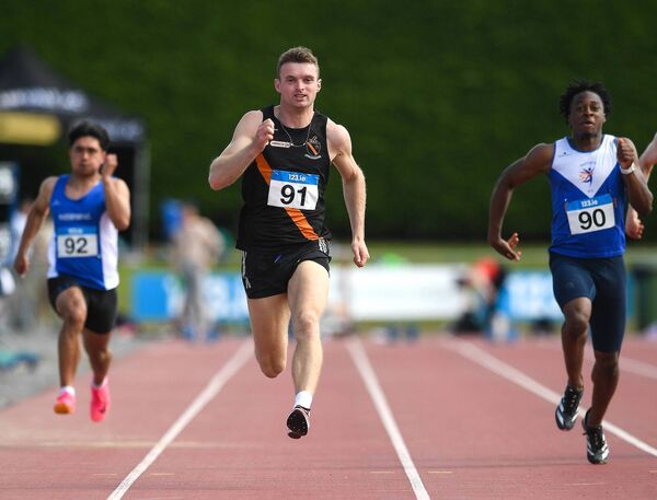 Marcus Lawler from Clonliffe Harriers AC on his way to winning the Premier Men's 100m Final 