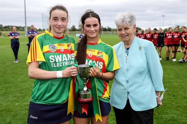 Carlow joint captains Alice Dalton and Sarah Murphy are presented with the trophy by former President of The Camogie Association Phyllis Breslin Photo: ©INPHO/Laszlo Geczo Carlow joint captains Alice Dalton and Sarah Murphy are presented with the trophy by former President of The Camogie Association Phyllis Breslin Photo: ©INPHO/Laszlo Geczo