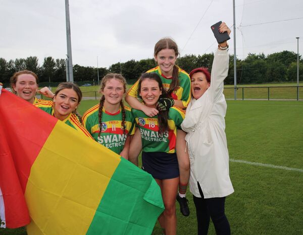 Debbie Brennan Challoner celebrates the Carlow camogie win with her daughter Paige who is being carried by Collette O'Brien. Debbie Brennan Challoner celebrates the Carlow camogie win with her daughter Paige who is being carried by Collette O'Brien.