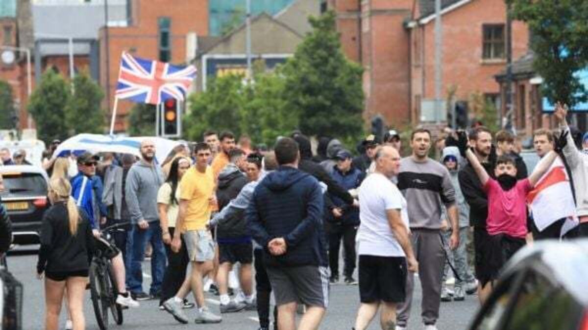 Police attacked in Belfast and suspected hate crime victim in serious condition