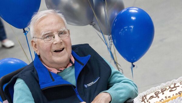Founder Paddy Byrne cuts a cake to mark the occasion as friends and families of employees at Burnside Autocyl marked its 50th anniversary