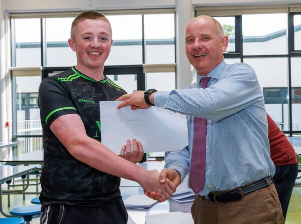 Sean Browne receives his leaving certificate results from former principal Michael Carew, Knockbeg St Mary's College. Photo: michaelorourkephotography.ie