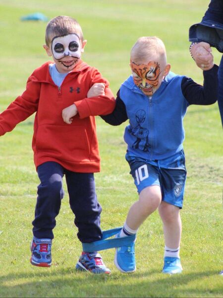 Jack Shannon and his friend taking part in the three-legged race after having their faces painted by the talented Ala