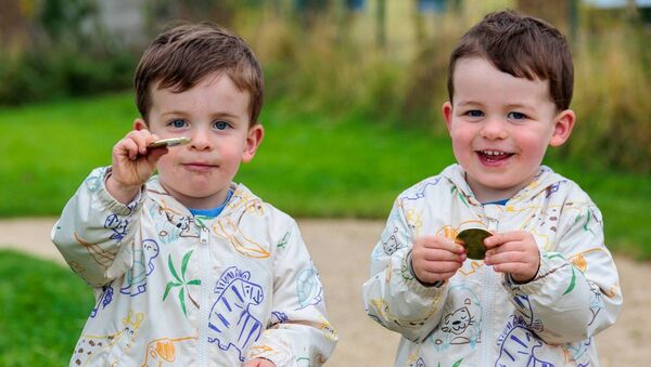 Twins Oisin and Tadhg Phelan proudly show the medals they received