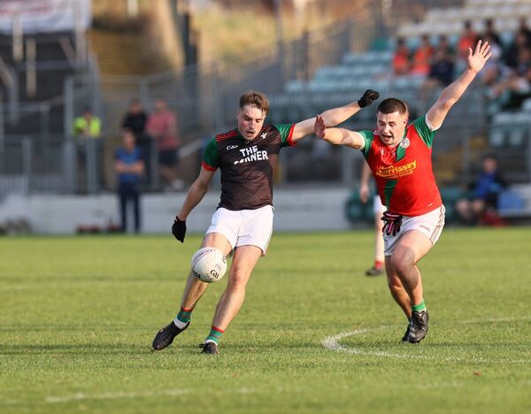 Clonmore's Luke Connolly shoots for a point as Cian Cashman tries to make a block for Palatine. Clonmore's Luke Connolly shoots for a point as Cian Cashman tries to make a block for Palatine.