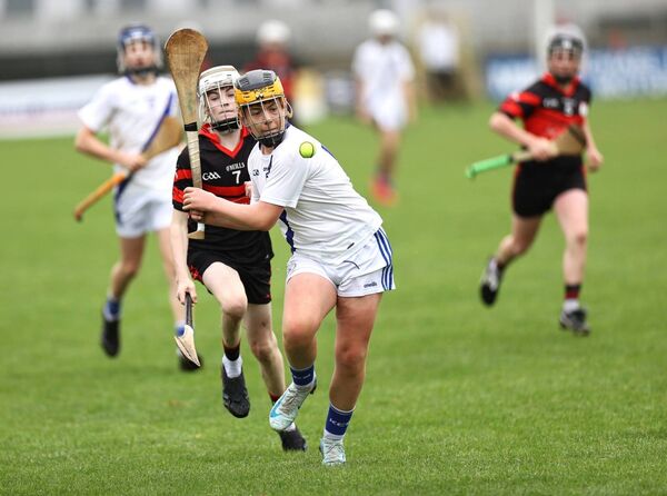 Allen Bowe scores a terrific point for Carlow Town despite the attempts from Ronan Murphy Mount Leinster Rangers to hook	Photo: Pat Ahern