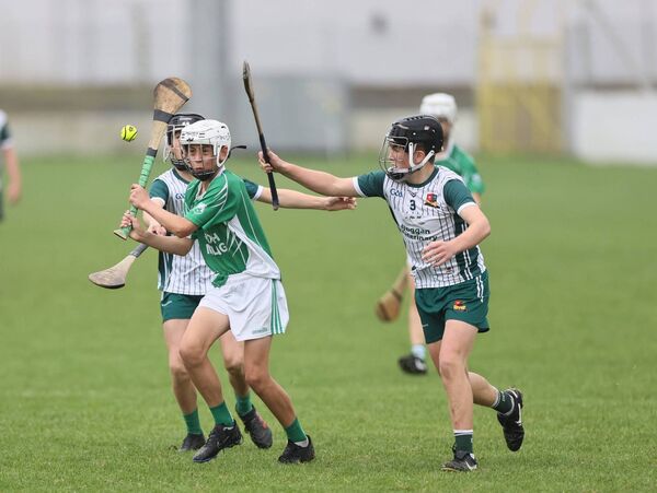 Dylan Ryan (St Mulllins) tries to strike the ball with Burren Rangers duo Joseph Keating and Shane McCaffrey trying to block and hook Photo: Pat Ahern