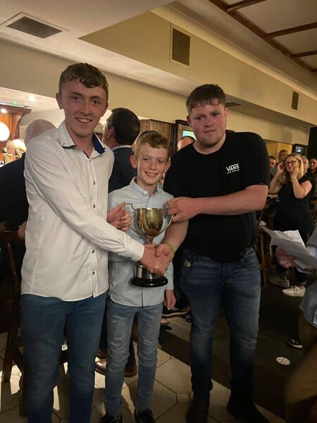Sean and Danny Byrne receiving the Thomas Doyle Perpetual Cup from Paddy Dunne