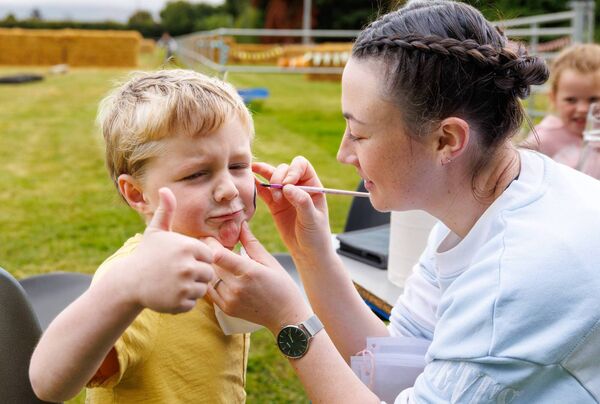Alfie Hunter has his face painted by Aoife Morrissey at the Ardattin NS and Community Development Group's BBQ at the Ardattin Community Hall. Photo: michaelorourkephotography.ie