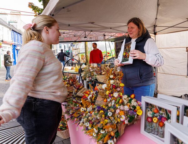 Tori Lyons checks out the flowers of Daniella Bogdan of Daniella’s Happy Flowers at the Carlow Farmer’s Market 