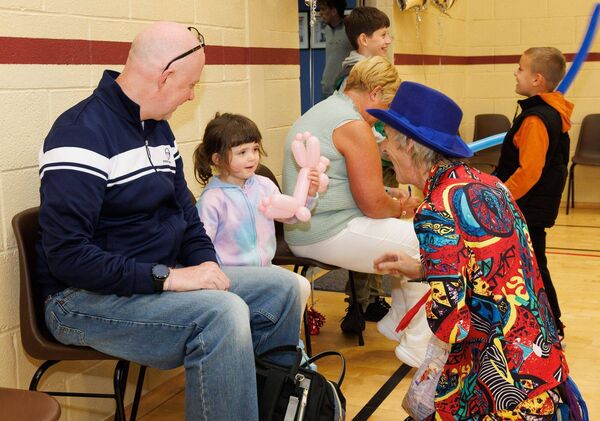 Mr Happy creates a balloon animal for Sorcha Curry during the Ballon Community Centre 10th anniversary celebrations, also pictured Sorcha's dad Paul Mr Happy creates a balloon animal for Sorcha Curry during the Ballon Community Centre 10th anniversary celebrations, also pictured Sorcha's dad Paul