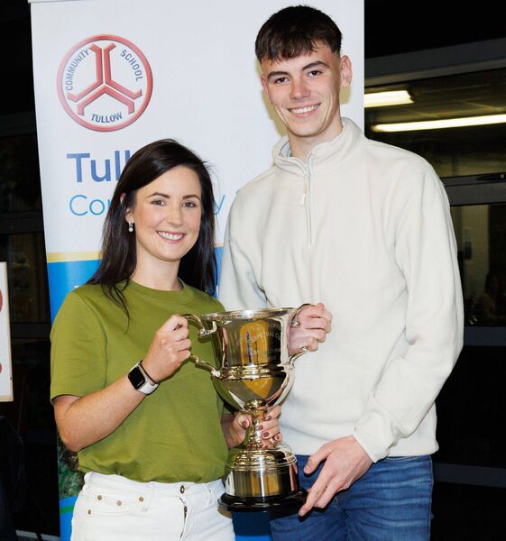 Conor Brophy receives the agricultural science award from Laura Brophy