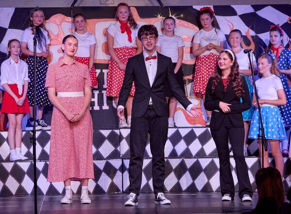 Dylan Byrne as 'Vince Fontaine' with Patricia Marcu as 'Patti Simcox' and Sophie Kavanagh as 'Ms Lynch'