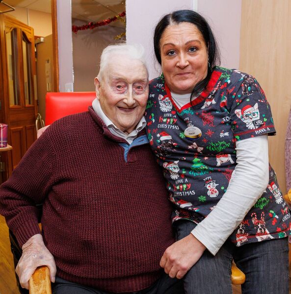 Liam Mullins, at 99 the oldest resident, is pictured with staff member Tracey Coogan