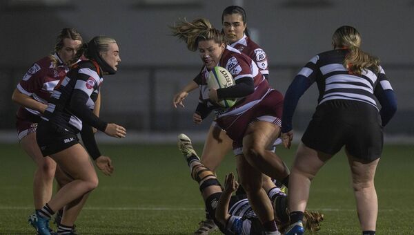Tullow's Anna O'Neill slips away from Lesley Ring of Old Belvedere. Photo; Thomas Nolan Photography.