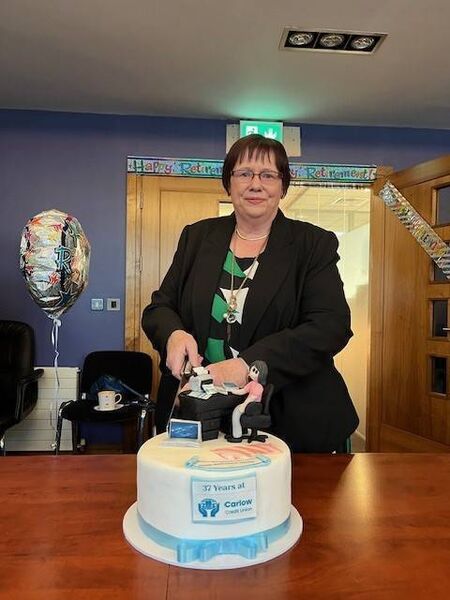 Marian O'Toole cuts her retirement cake at Carlow Credit Union