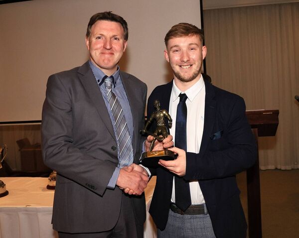 Burren Rangers Junior hurling manager Jarlath Bolger presents Joe Holden with the Junior Player of the Year Award