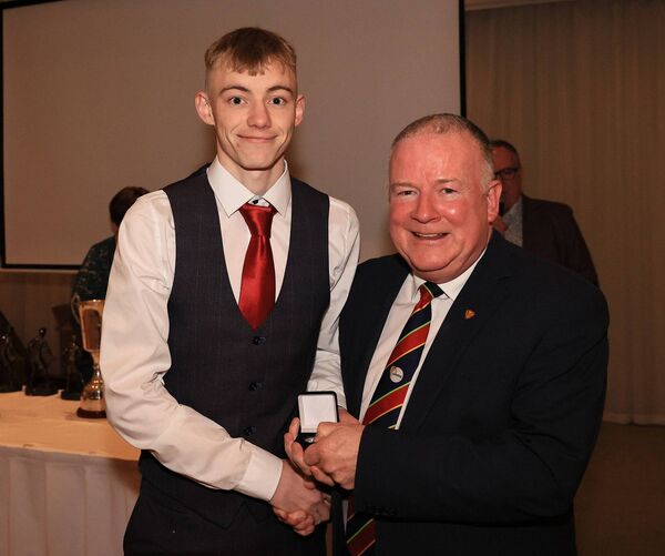 Carlow GAA Chairman Jim Bolger presents Moling English Hayden with his Junior Hurling Championship medal.