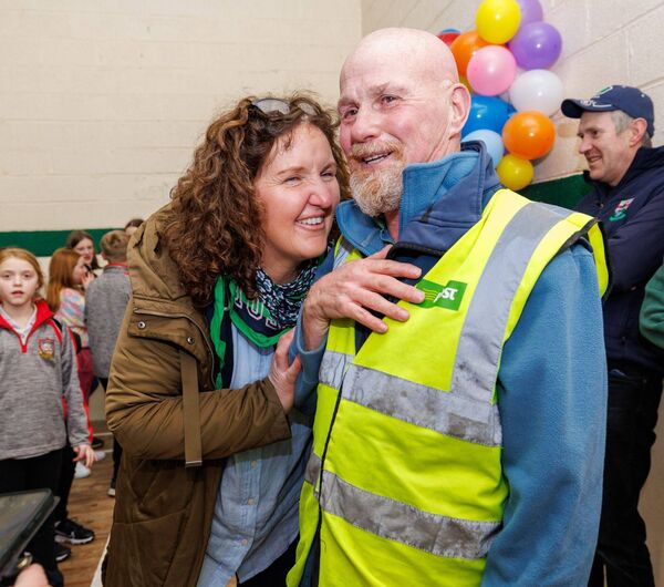 Frankie Brennan is congratulated by Sarah Malone during his surprise retirement party