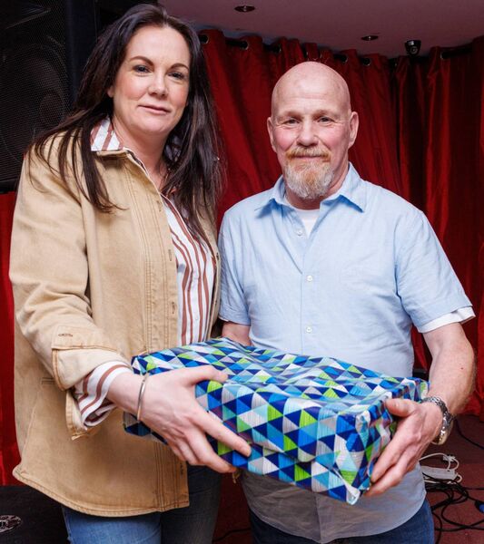 Laura Vance makes a presentation to postman Frankie Brennan on behalf of the community Laura Vance makes a presentation to postman Frankie Brennan on behalf of the community