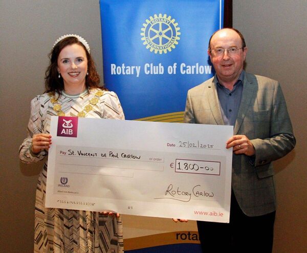 Eddie Deegan, representing the St Vincent De Paul is presented with a cheque by Rotary Club president, Aoife Doyle