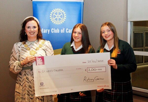 Aoife Doyle from the Rotatry Club with Caoimhe Fanning and April Kehoe representing St Leo's College receive a cheque for their school in appreciation of the volunteering hours at the Remembrance Tree 