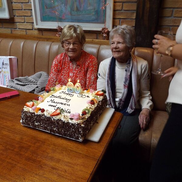 Bridie and Maureen get ready to blow out their birthday candles.