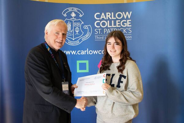 English and History student, Emma Mahon receives her award from college president, Fr Conn Ó Maoldhomhnaigh