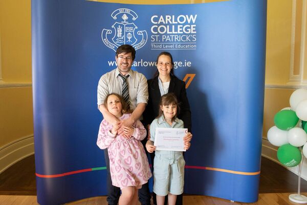 Diarmuid Commins from Graiguecullen celebrates his Progression Scholarship with his wife Debora Severino and their children, Niamh and Sadhbh