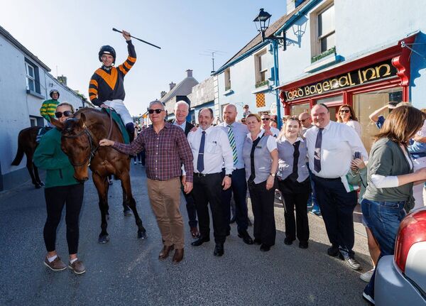 Patrick Mullins on Randox Grand National winner Nick Rockett with groom Katie Walton, owner Stewart Andrew, trainer Willie Mullins and staff from the Lord Bagenal Inn Photo: michaelorourkephotography.ie