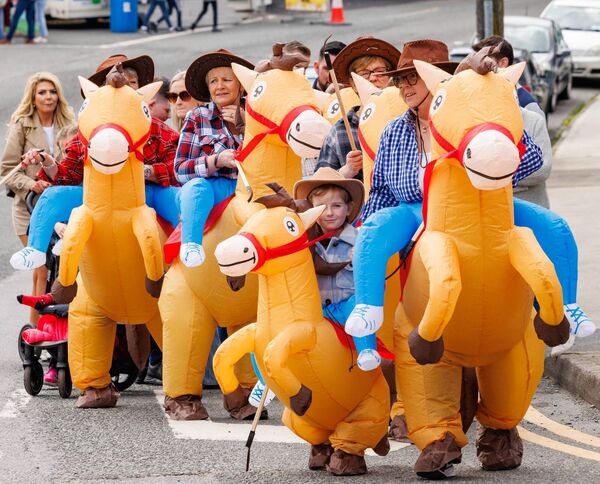 Inflatable horses and colourful costumed characters delight the crowd