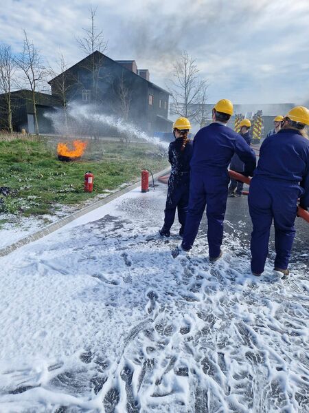 The students get practice putting out a fire