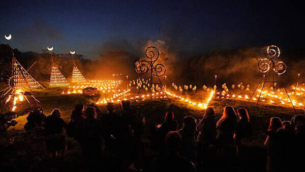 Spectators gather for ancient Celtic fire procession that welcomes summer