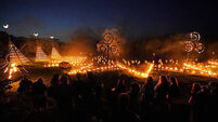 Spectators gather for ancient Celtic fire procession that welcomes summer