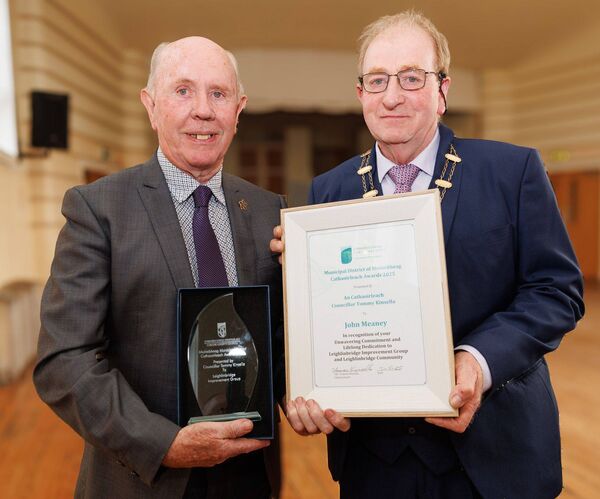 John Meane accepts his 'Cathaoirleach Award' from cllr Tommy Kinsella