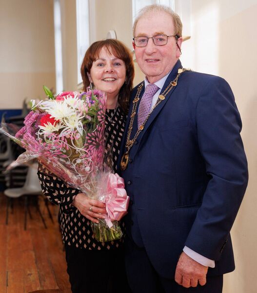 Cathaoirleach Tommy Kinsella presents a bouquet of flowers to Tommie Hickson of Carlow County Council during the awards evening