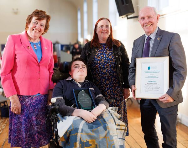 John Meaney, who received a Cathaoirleach Award during the awards evening in McGrath Hall, with his wife Mary, daughter Therese and his grandson Leon