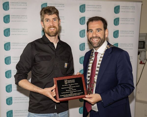 Brian Byrne accepts the award on behalf of his daughter Beatrice Byrne