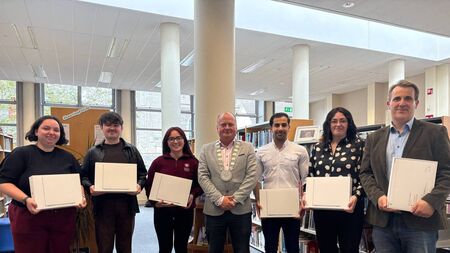 Council bursary gifts laptops to students