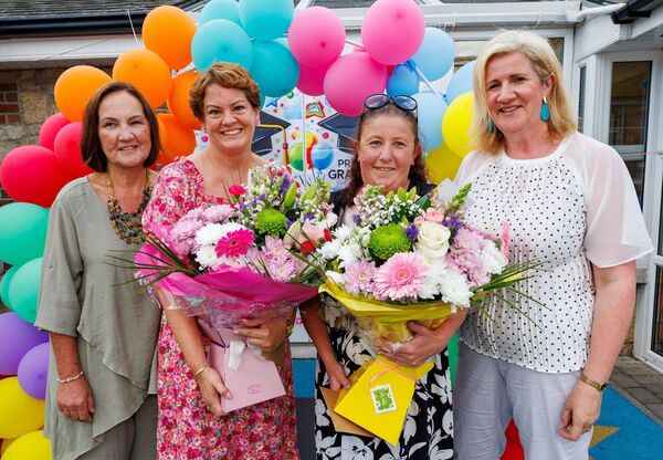 Antoinette Cummins and Anna Rogers receive bouquets of flowers from manager Helen Murphy (left) and Avril Bolger (chairperson of the board of management) to mark their 25 years of service
