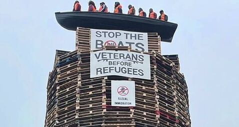 Calls for removal of migrant effigies in boat placed on loyalist bonfire in NI