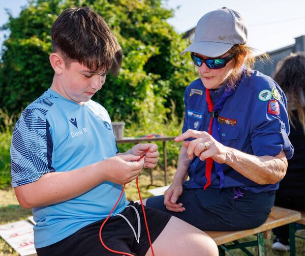 Marie-Therese Byrne helps Vincent Condon make a 'reef knot' during the Fifth Carlow Town Scout Group's showcase event