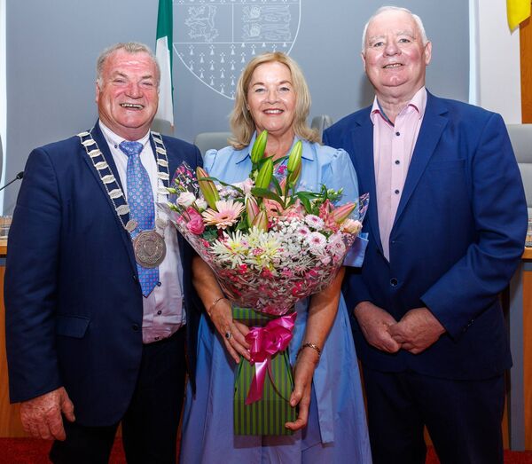 Cllr Ken Murnane (Cathaoirleach Carlow County Council) makes a presentation of a bouquet of flowers to Mary Pender wife of John during the presentation to honour his 40 years as an elective member of Carlow County Council Cllr Ken Murnane (Cathaoirleach Carlow County Council) makes a presentation of a bouquet of flowers to Mary Pender wife of John during the presentation to honour his 40 years as an elective member of Carlow County Council