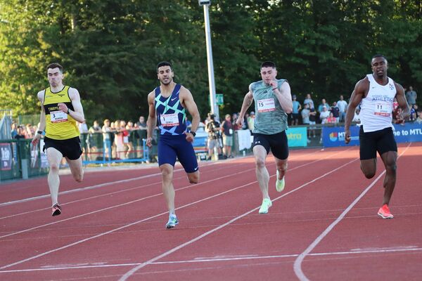 Adam Murphy (Tinryland) racing in the 200m (left)