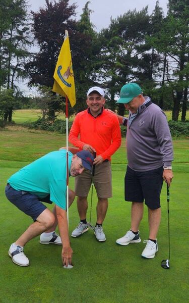 John McHugh picks the ball out of the fifth hole with playing partners Omar Bhamjee and Ronan McGrane John McHugh picks the ball out of the fifth hole with playing partners Omar Bhamjee and Ronan McGrane
