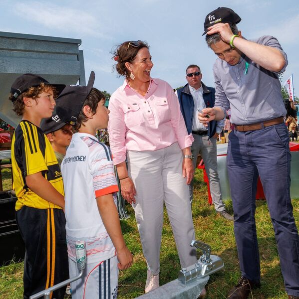 Tánaiste Simon Harris try on a baseball cap during the Tullow Show also shown is Catherine Callaghan TD and brothers Joe, John and Sam Kiely